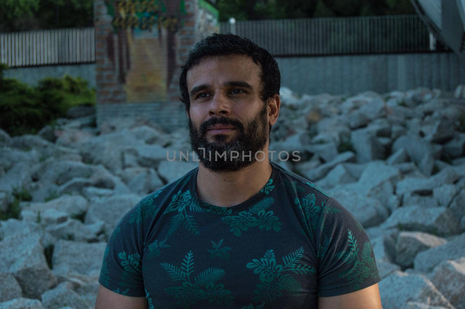 Man playing sports in a park in the afternoon and wearing a flower T-shirt