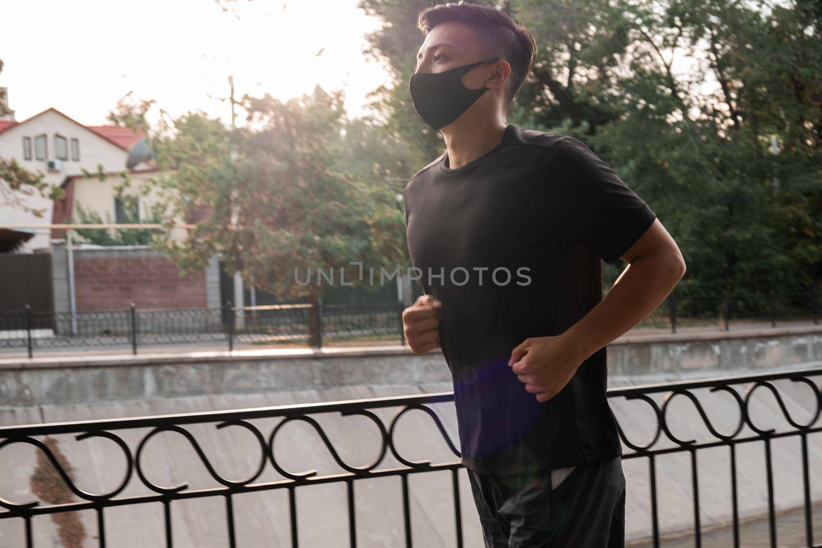 An Asian man running in the city, in the evening. Kazakhstan