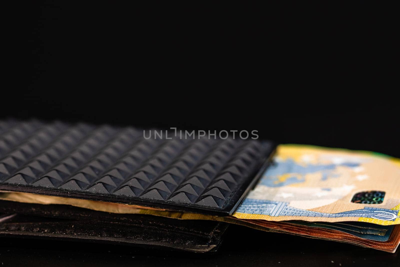 Euro banknotes in black wallet isolated.