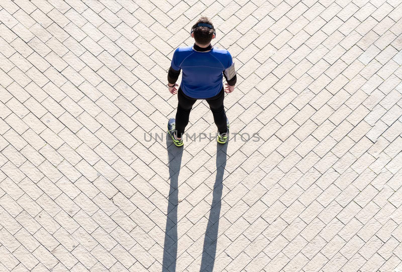 view from above of a young man working out listening to music. concept of healthy living.