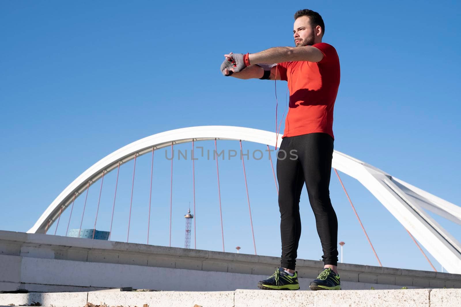 Low angle shot of a young male warming up for a workout