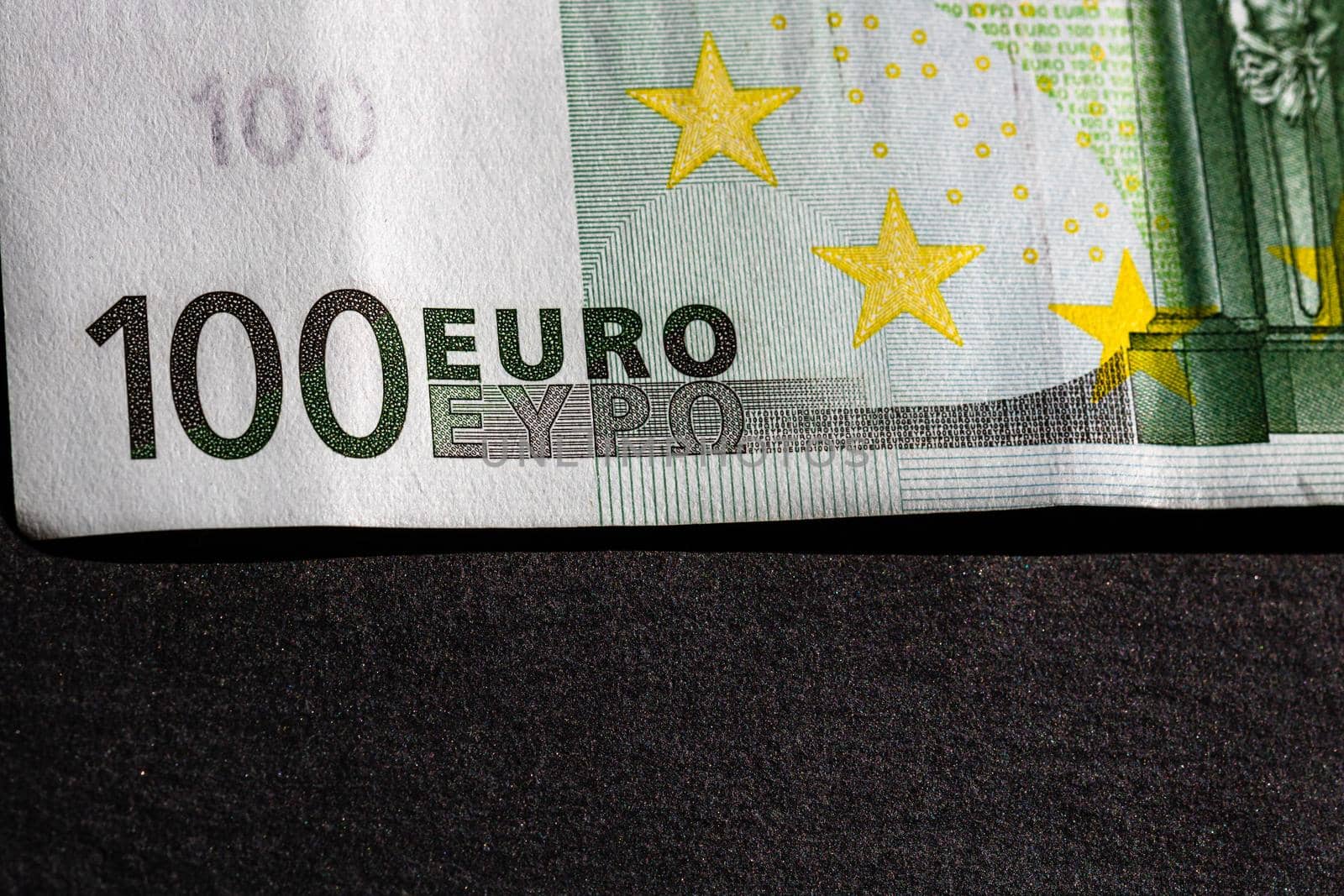 Selective focus on detail of euro banknotes. Close up macro detail of money banknotes, 100 euro isolated. World money concept, inflation and economy concept