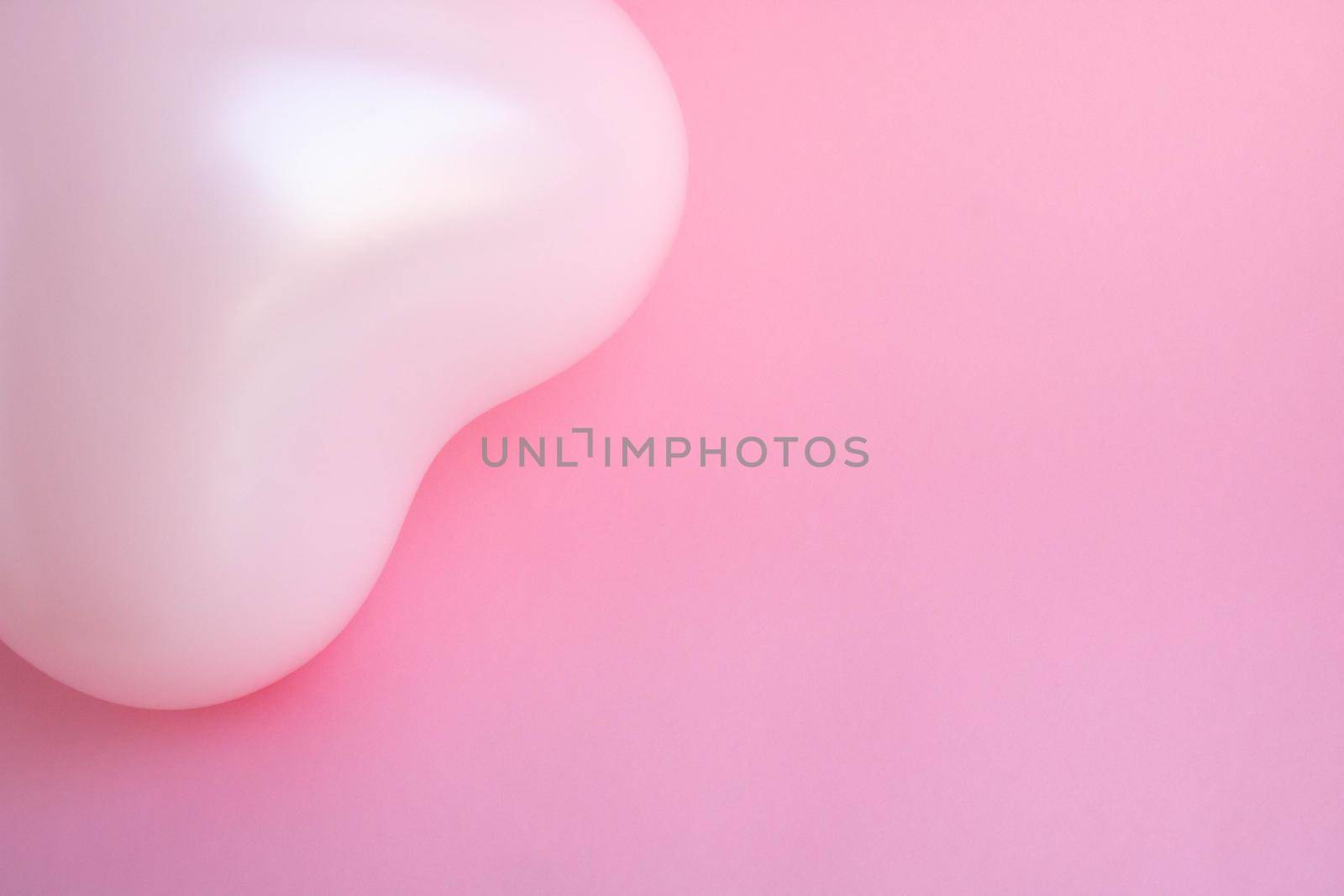 Pink balloon in the shape of a heart on a pink background. Wedding concept, Valentine's Day, photo zone, lovers. Banner. top view. Place for your text.