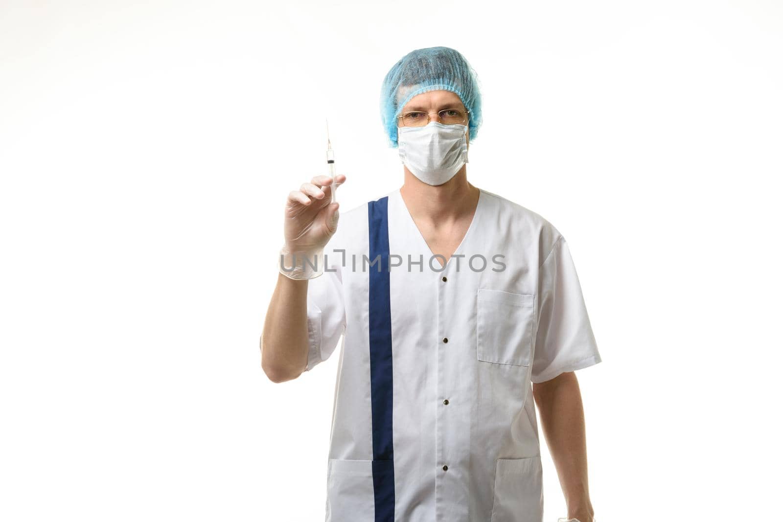 Surgeon holding a syringe in his hands and looking into the frame, isolated on white background