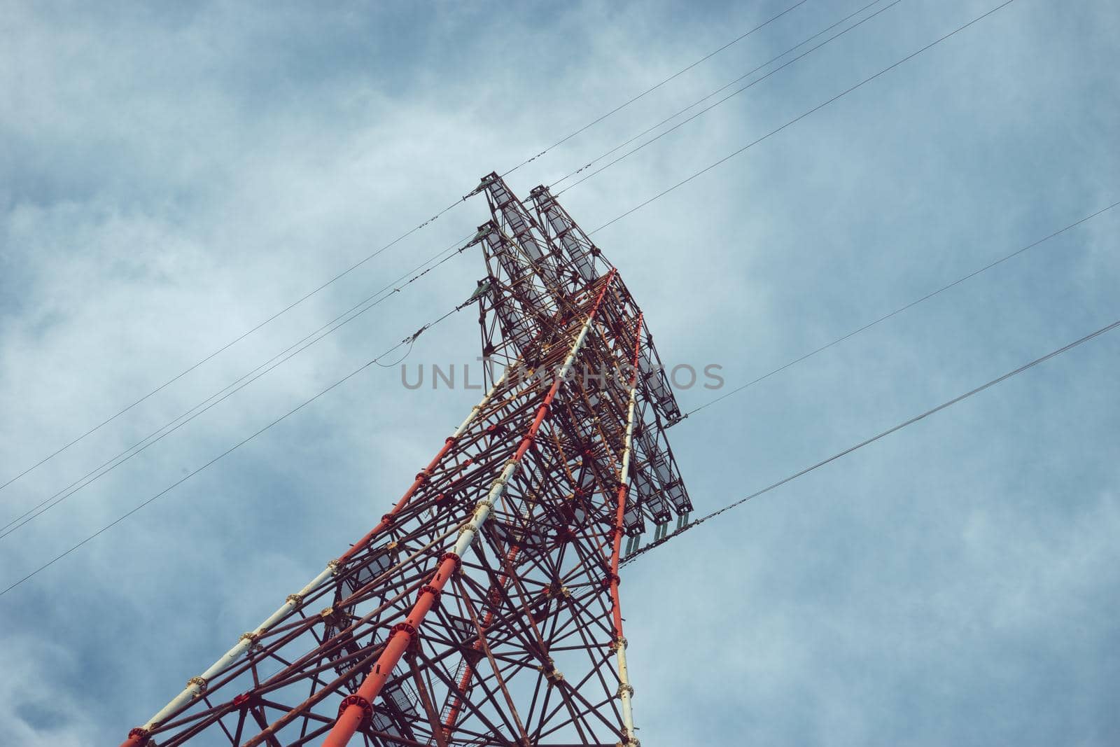 High-voltage tower against the cloudy sky.