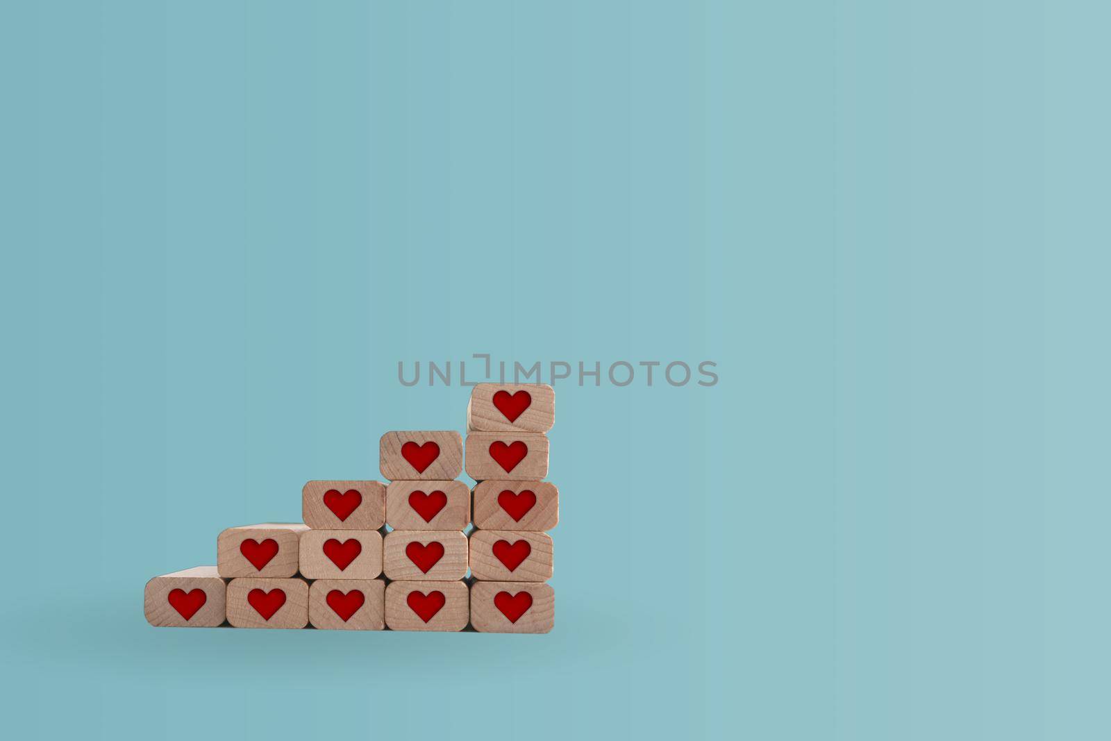 Heart icon on wooden step board with blank copy space background. Valentine love holiday concept.