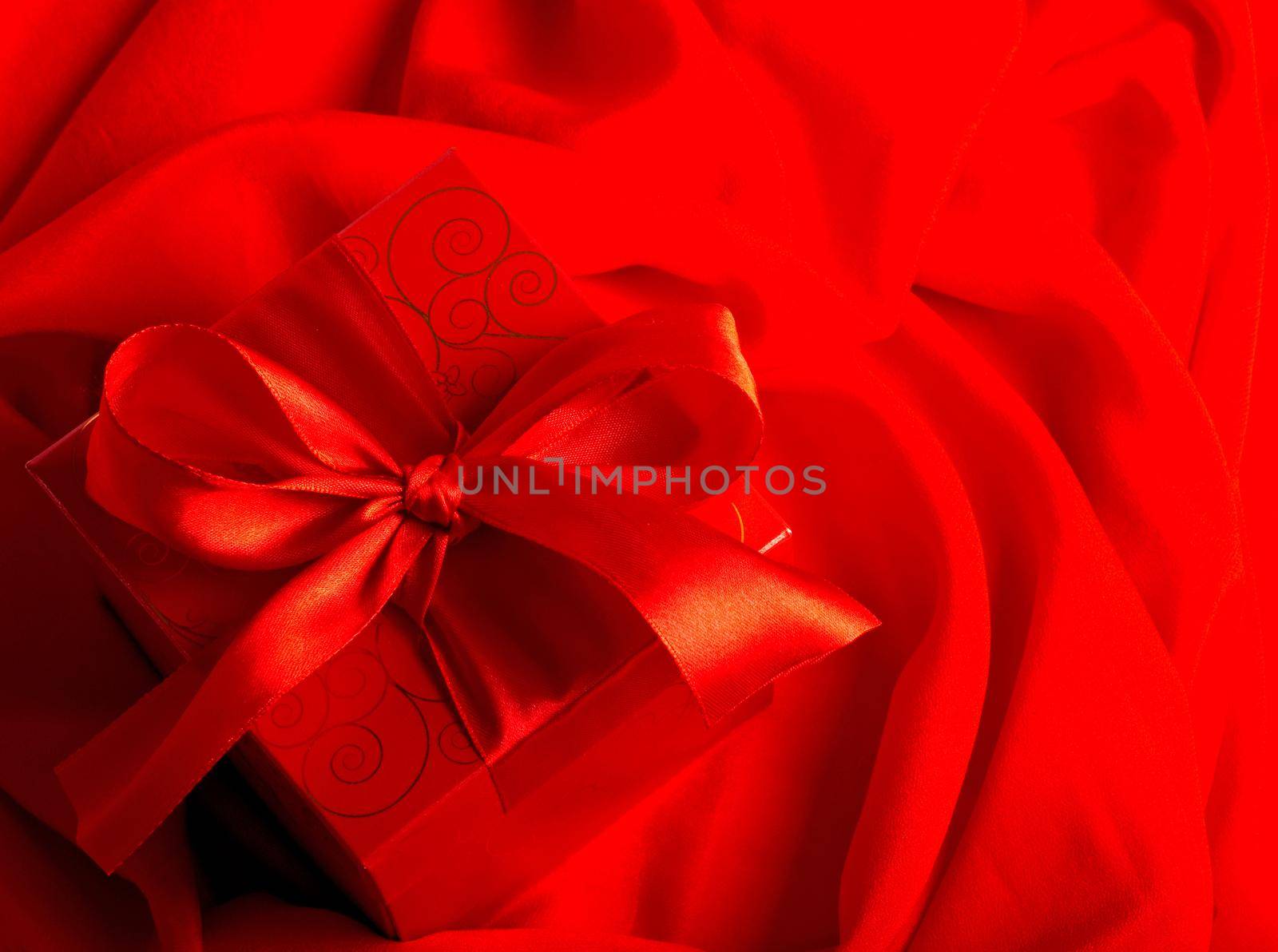 Valentine's day concept, gift with candle on a red background