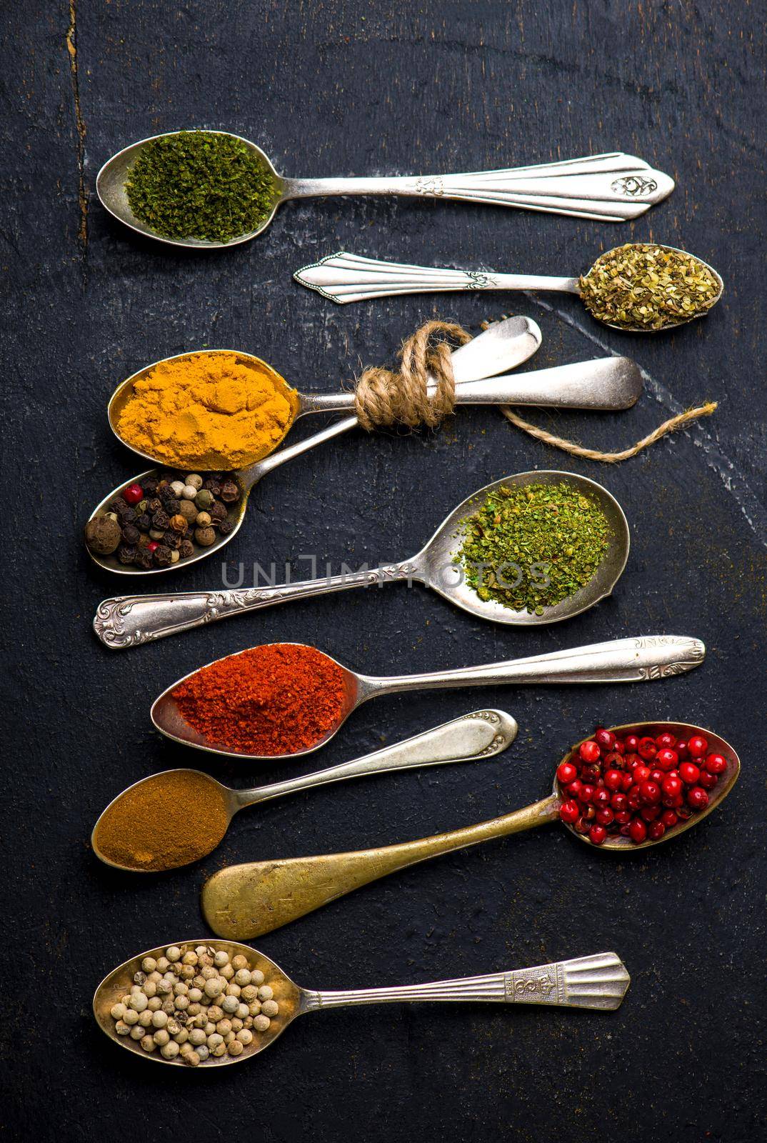 Various spices spoons on black table. Top view with copy space by aprilphoto