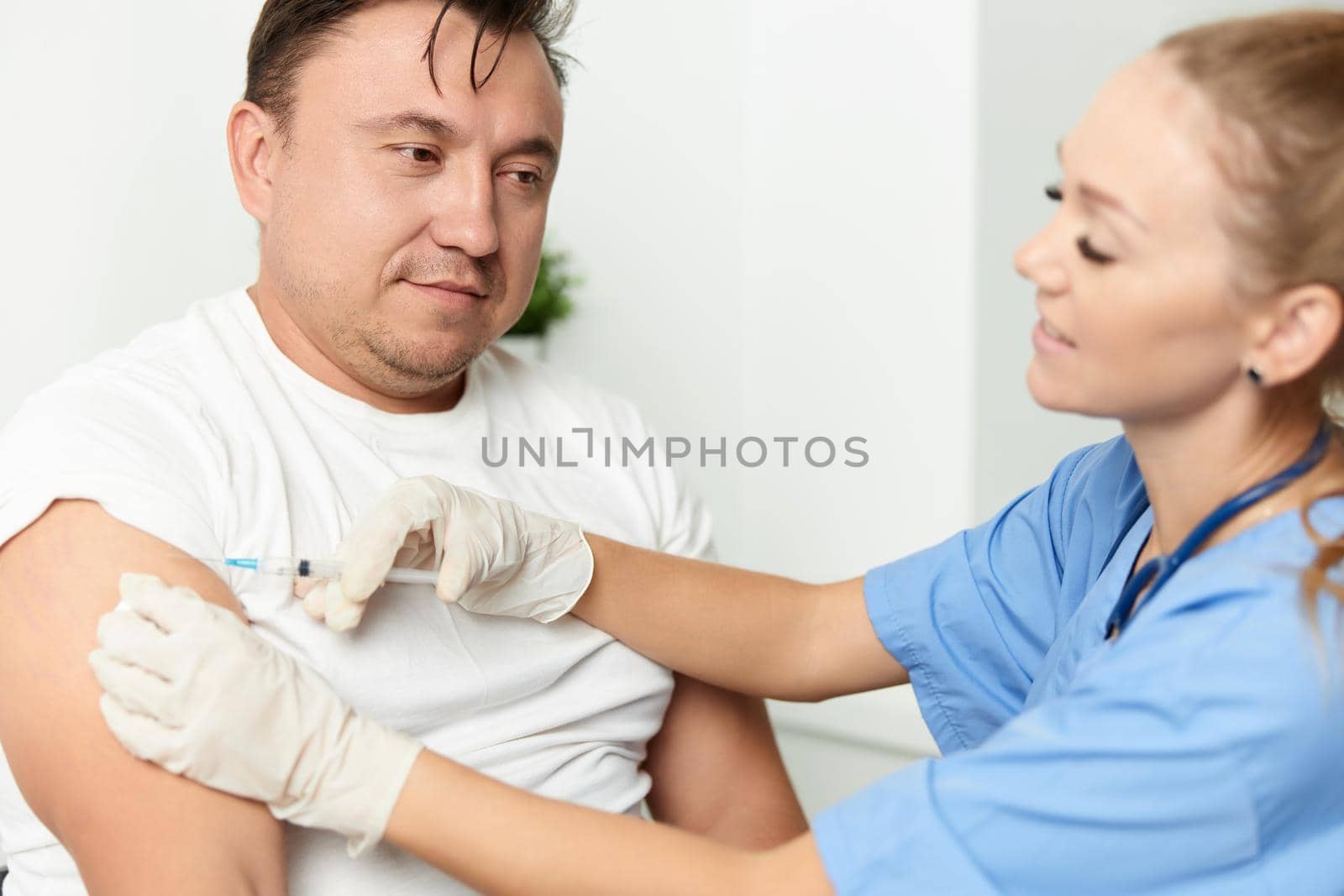 female doctor holding an injection to a patient. High quality photo