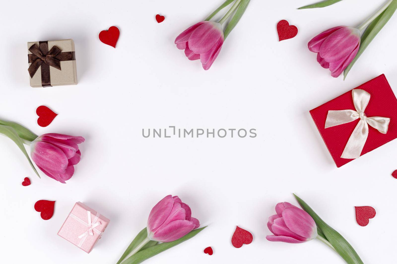 Pink tulips gifts and hearts on white by Yellowj