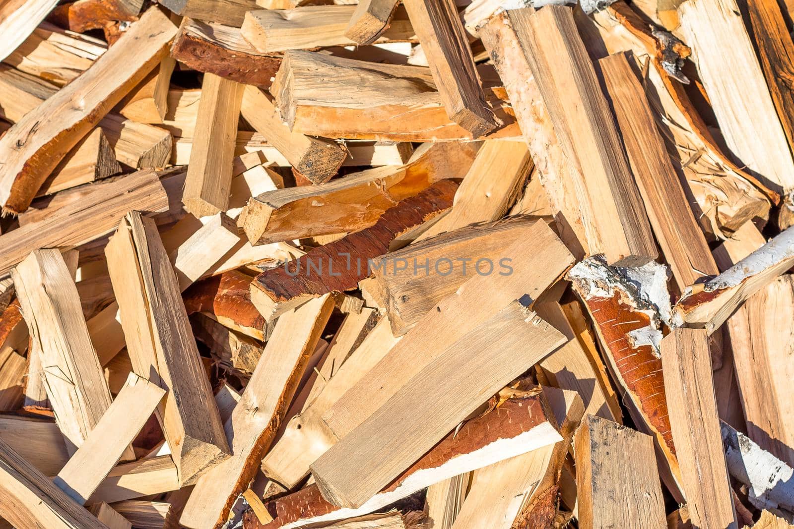 A pile of chopped birch wood. Firewood and biofuels by YevgeniySam