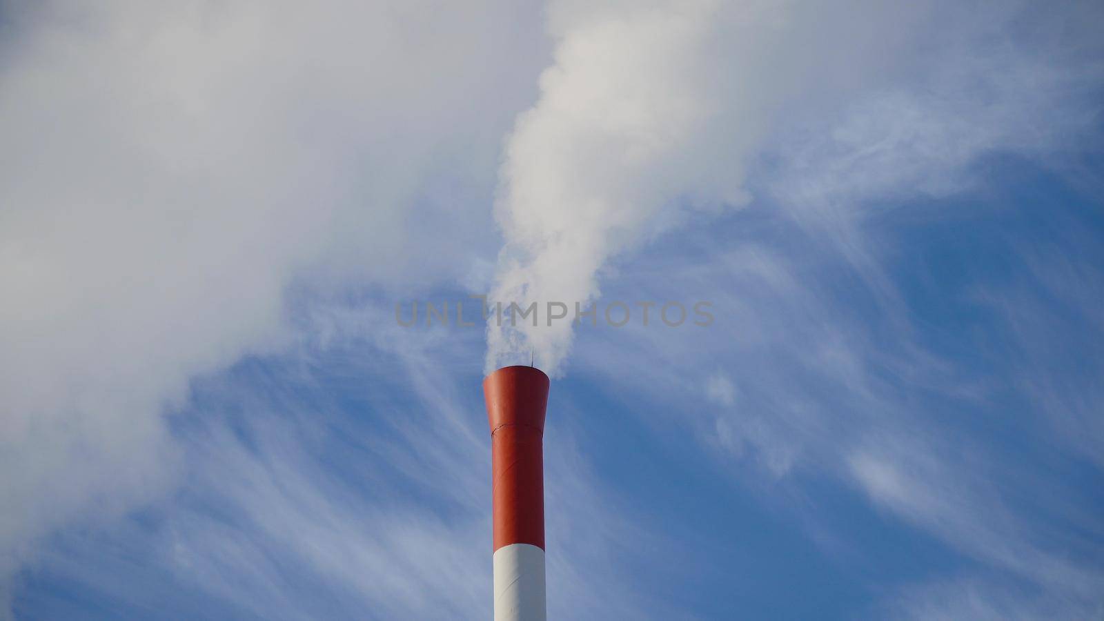 Boiler room in the winter season, from the chimneys rise up clouds of steam. Pipes of a thermal power plant. Boiler house, pipe plant, boiler plant.