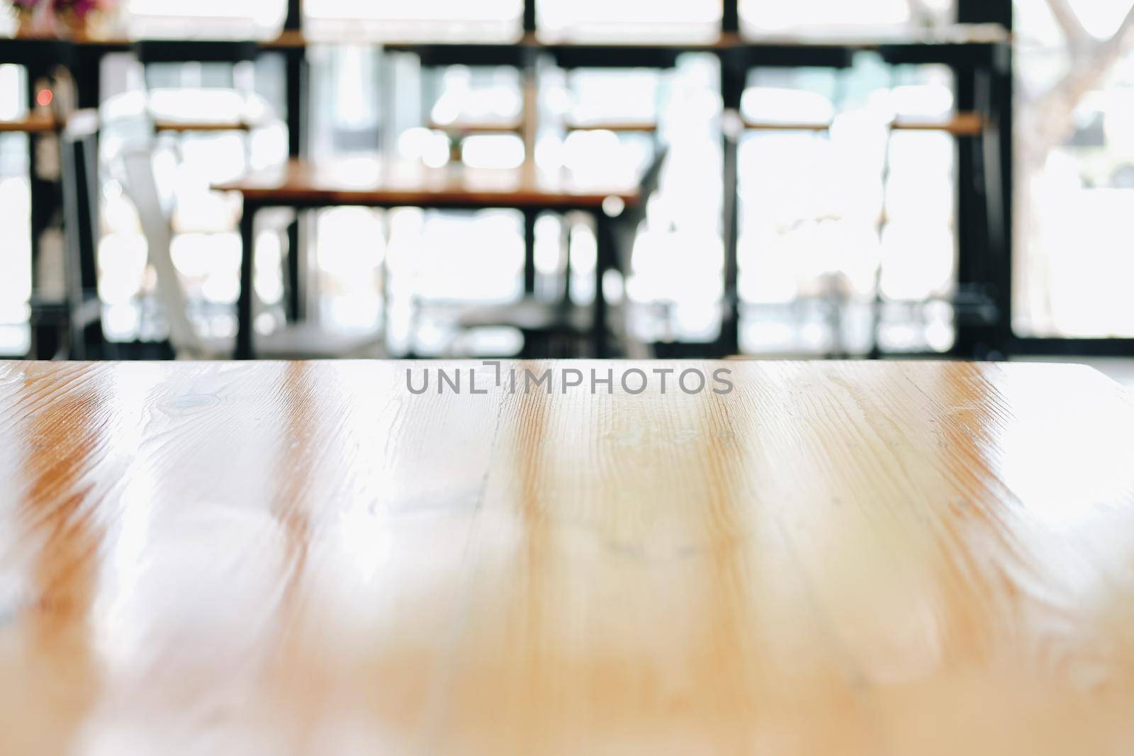 wooden table with cafe coffee shop defocused blur background