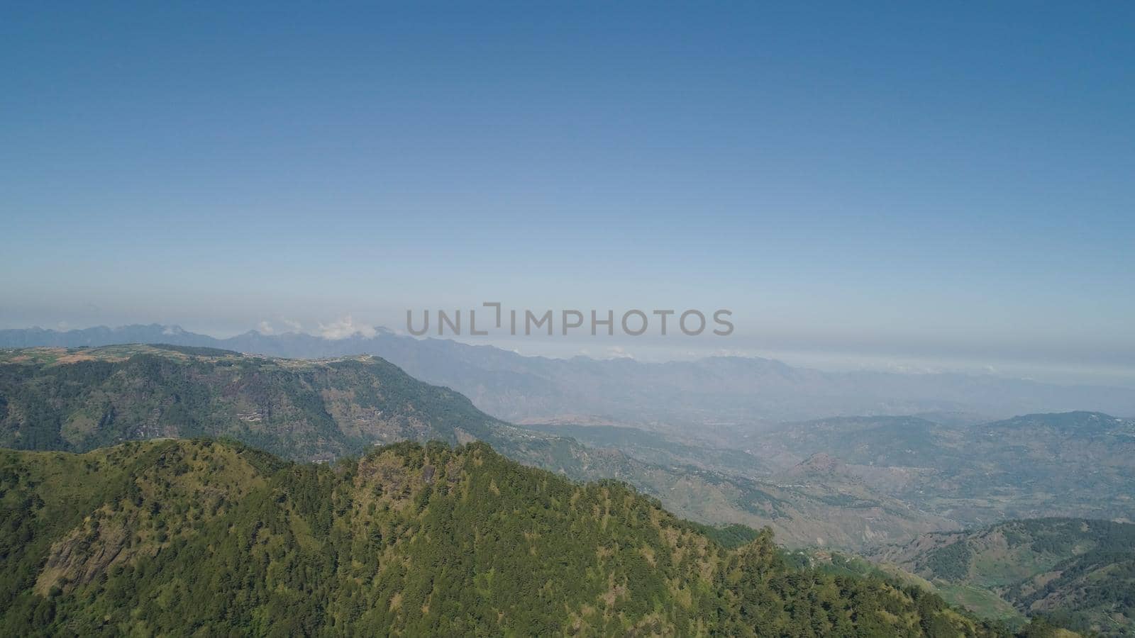 Aerial view of mountains covered forest, trees in clouds. Cordillera region. Luzon, Philippines. Slopes of mountains with evergreen vegetation. Mountainous tropical landscape.