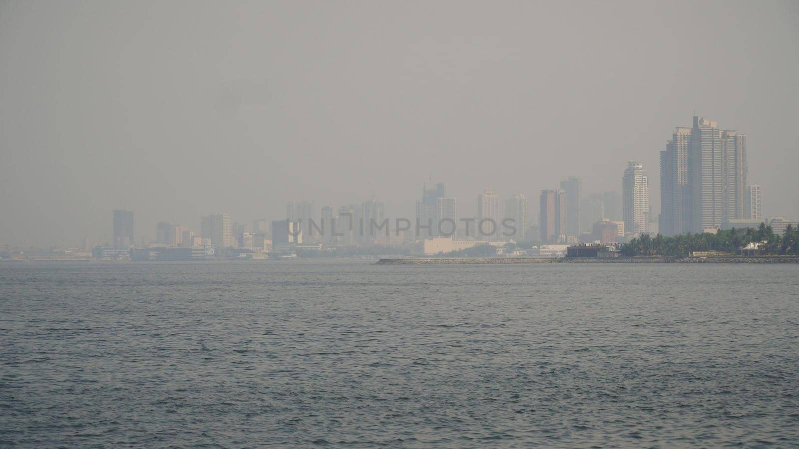 Panorama Manila city, skyscrapers and buildings. Seascape coastal city of Manila. Modern city by sea. Makati district. Travel concept.