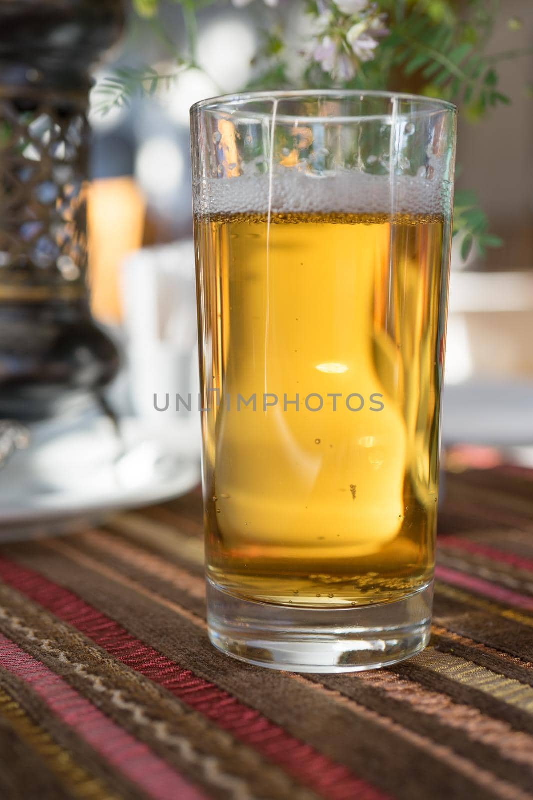 A glass of non-alcoholic beer in the Crimean Tatar cafe on the background of the interior.