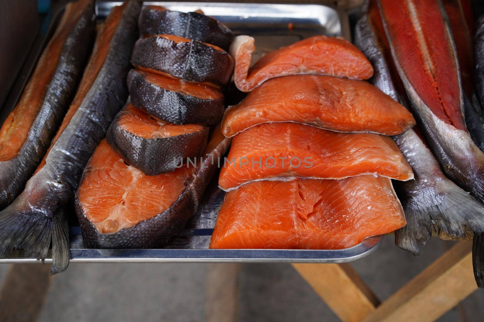 Smoked red fish on a metal tray. Fish market