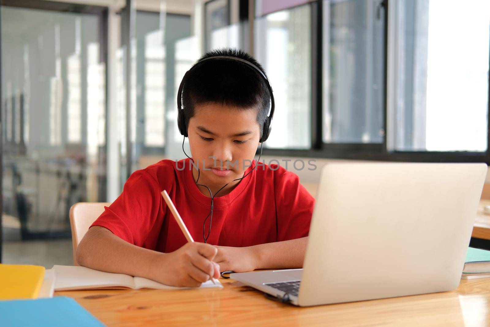 asian boy student studying learning lesson online. remote meeting distance education at home