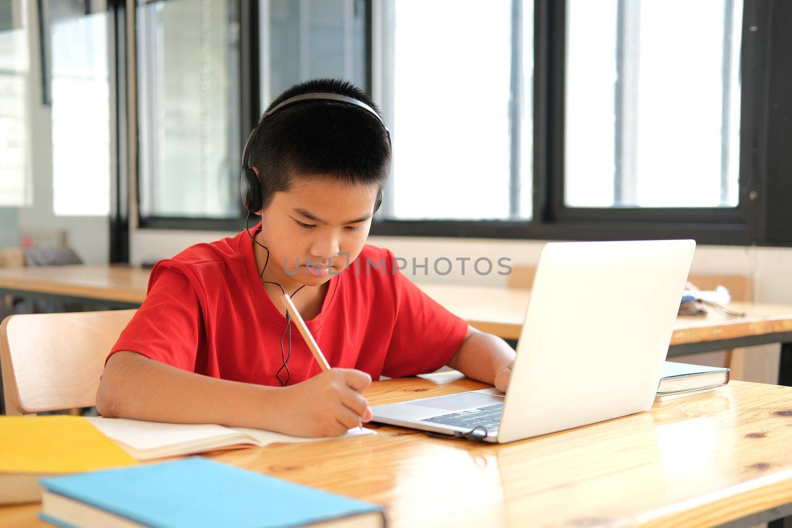 asian boy student studying learning lesson online. remote meeting distance education at home