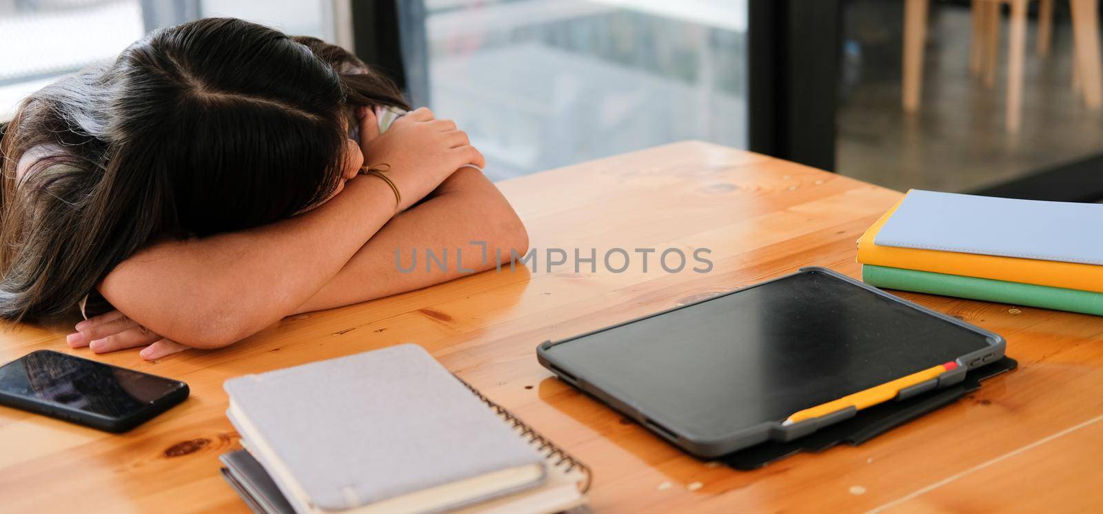 tired exhausted girl student sleeping after studying hard exam in library by pp99