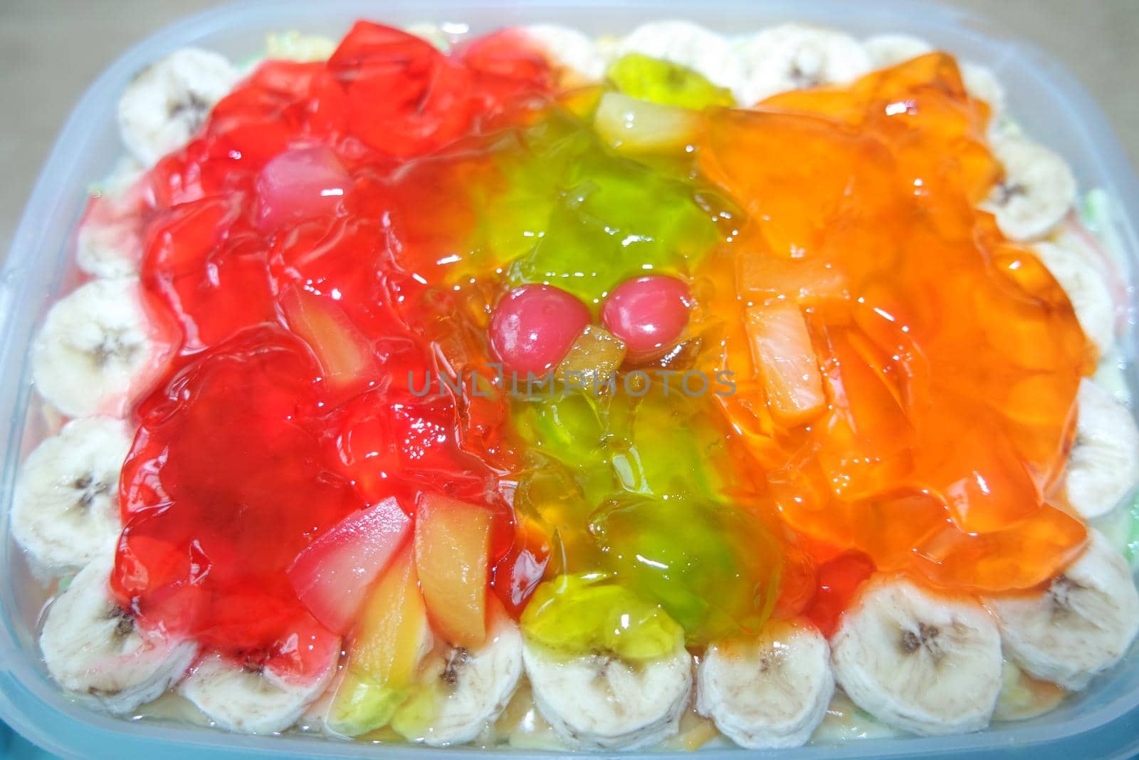 Creamy custard sweet dish with with different slices layered on surface. A top view of home made custard, a dairy products for dessert after meal.