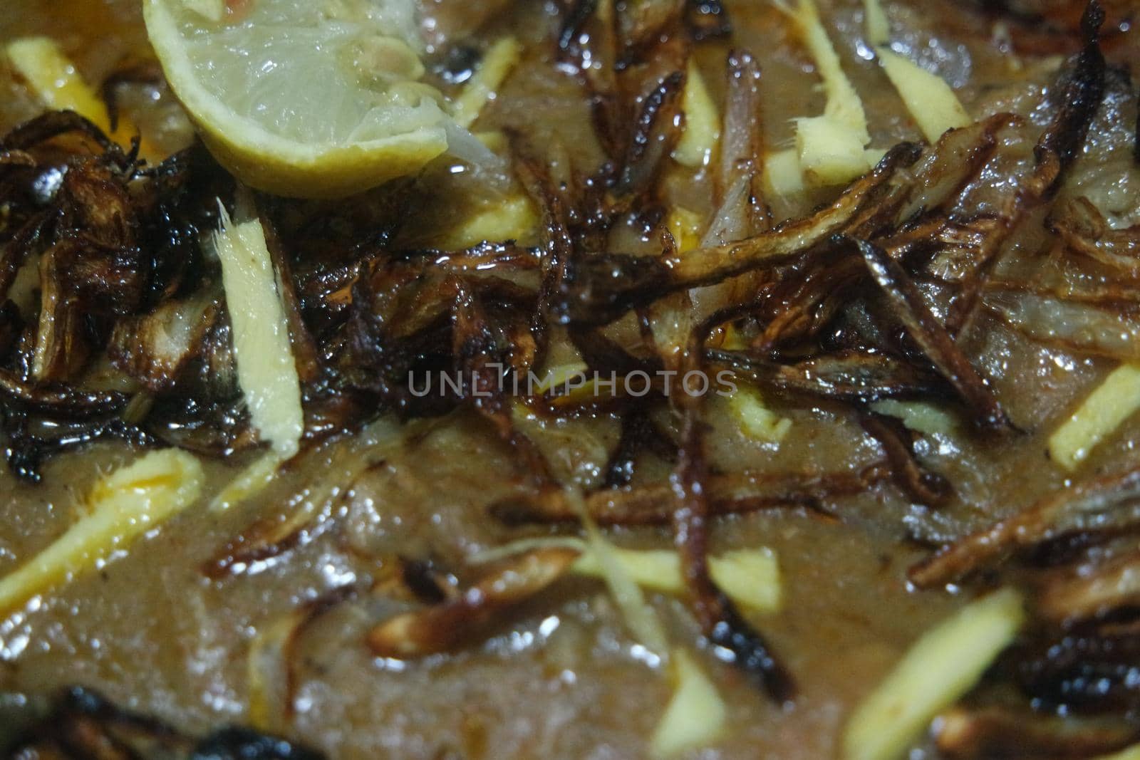 Closeup view of traditional Pakistani Haleem dish with salad and Lemon juice.