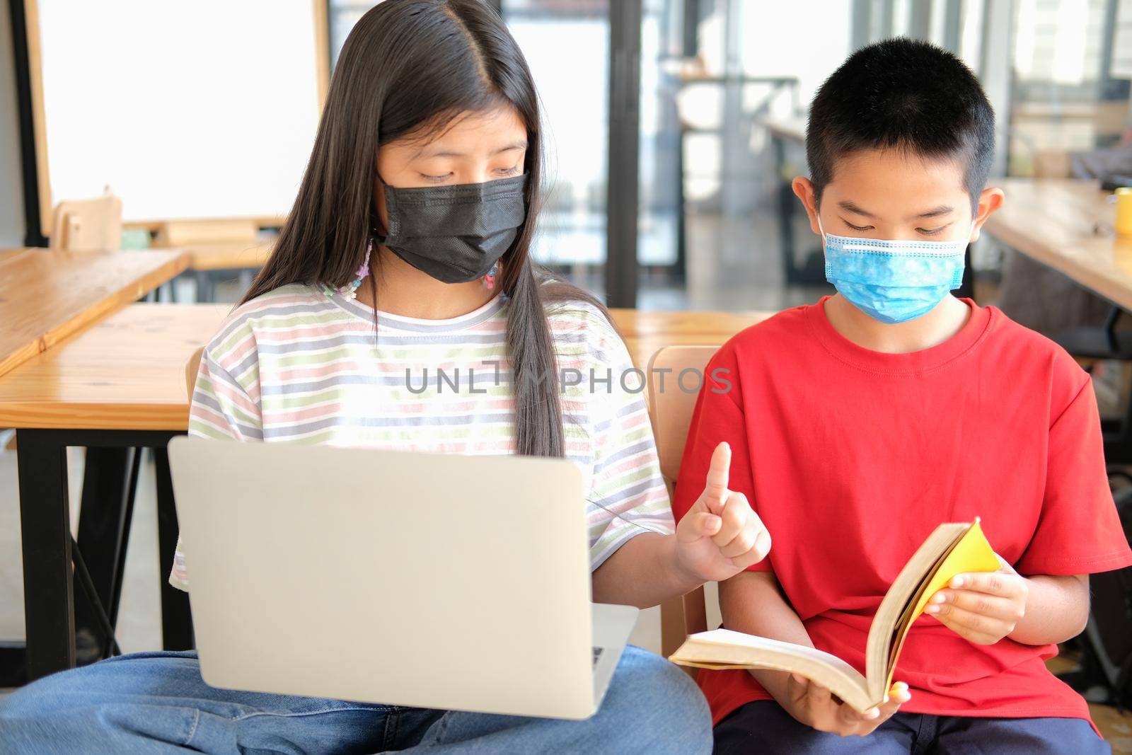 asian boy girl student wearing face mask studying learning lesson online. remote meeting distance education at home