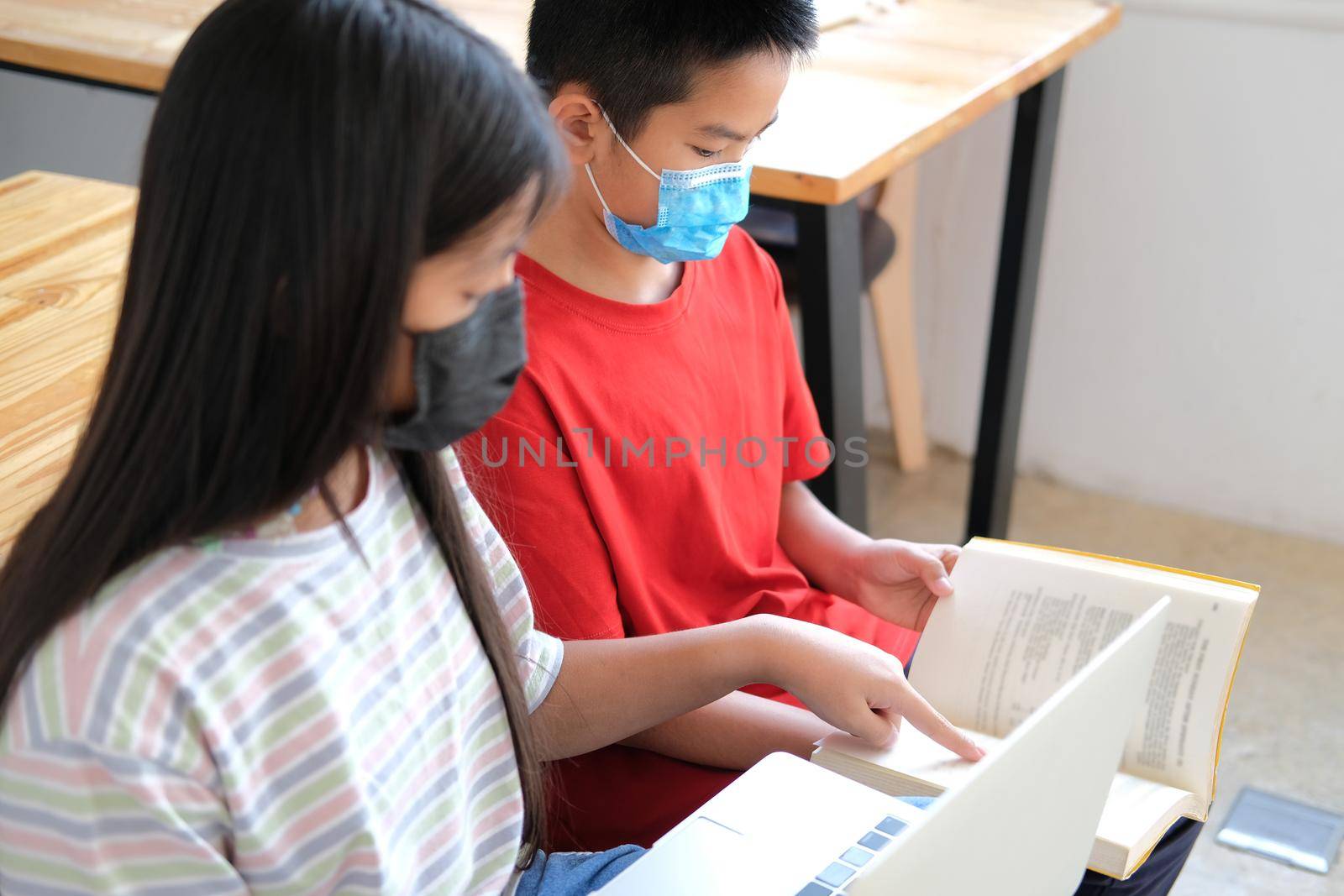 asian boy girl student wearing face mask studying learning lesson online. remote meeting distance education at home