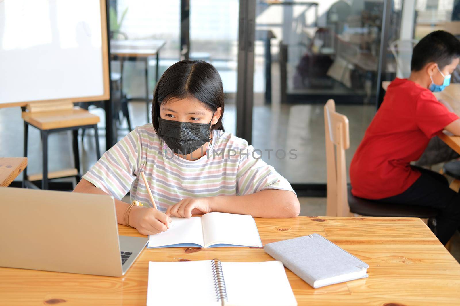 asian boy girl student wearing face mask studying learning lesson online. remote meeting distance education at home