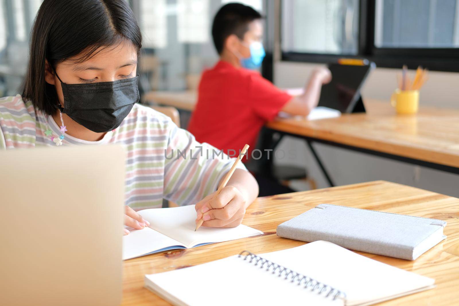 asian boy girl student wearing face mask studying learning lesson online. remote meeting distance education at home