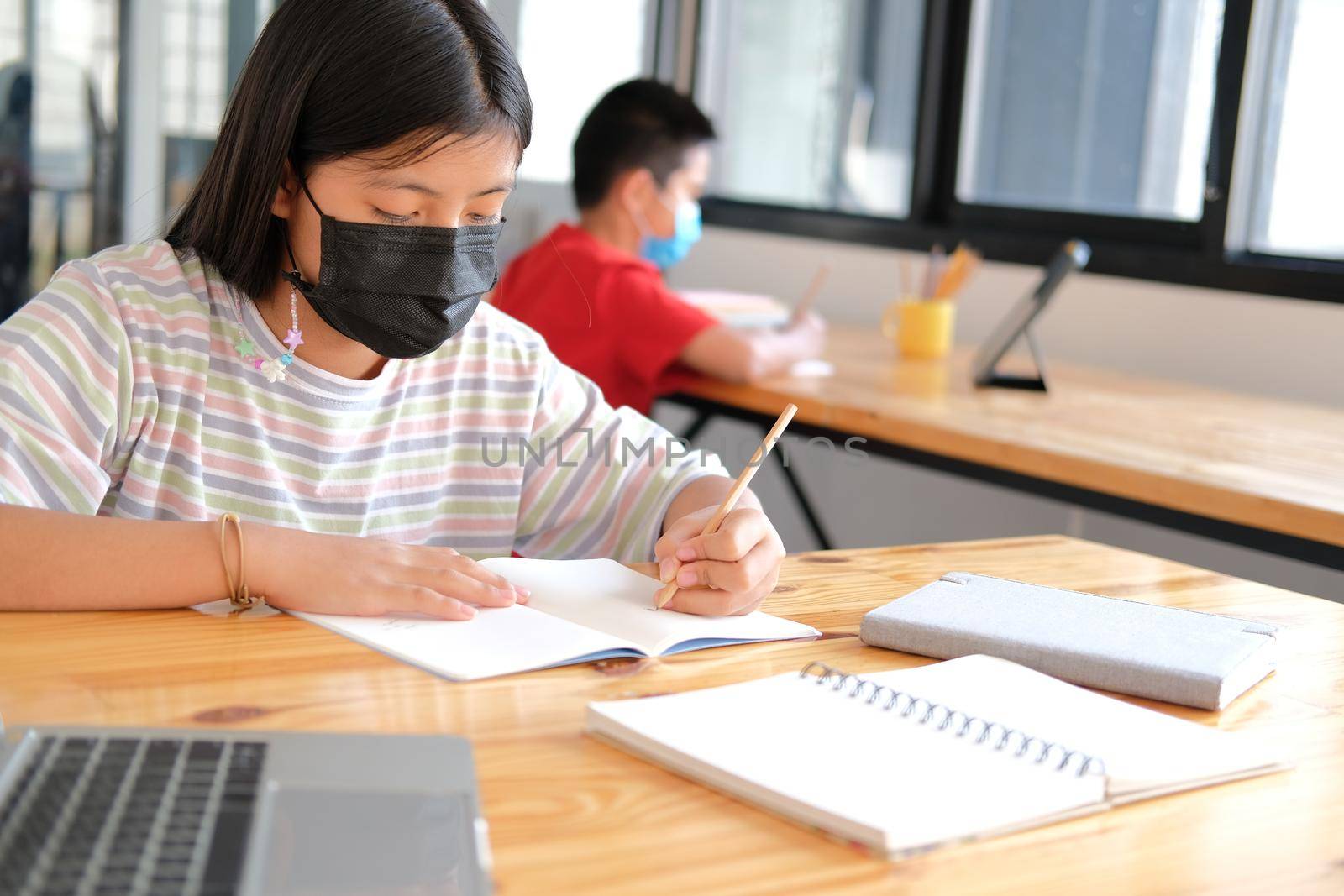 asian boy girl student wearing face mask studying learning lesson online. remote meeting distance education at home