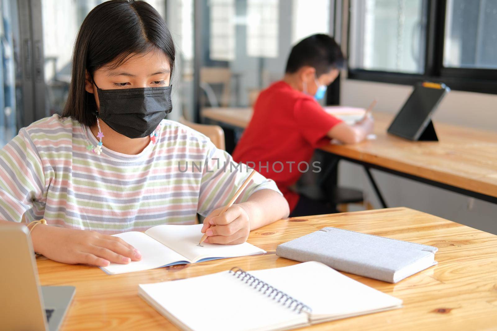 asian boy girl student wearing face mask studying learning lesson online. remote meeting distance education at home