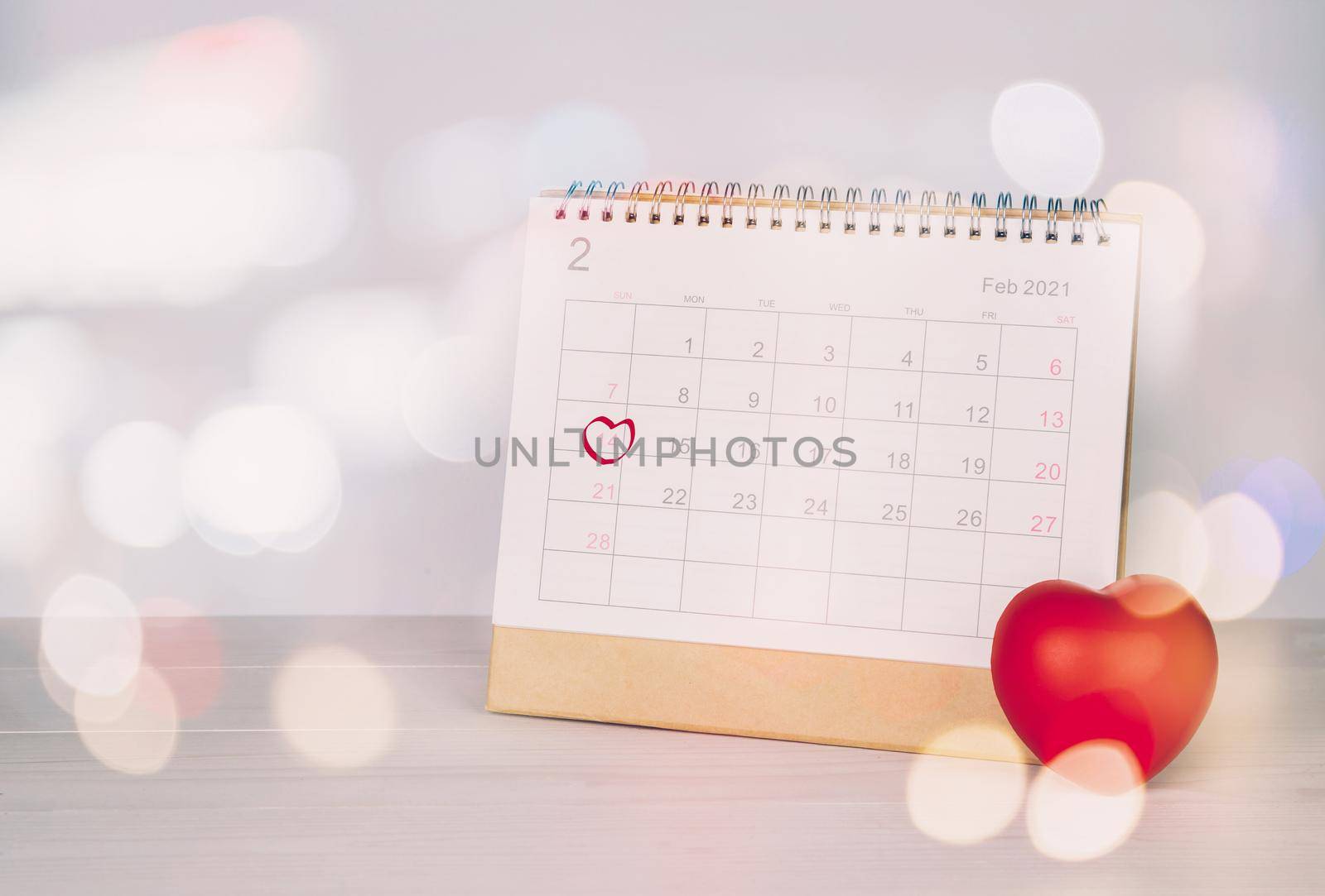 Calendar and heart shape with memo 14 February Valentine day on desk, reminder for surprise of love, romance and sweet, celebration and decoration, date and planner, nobody, top view, holiday concept. by nnudoo