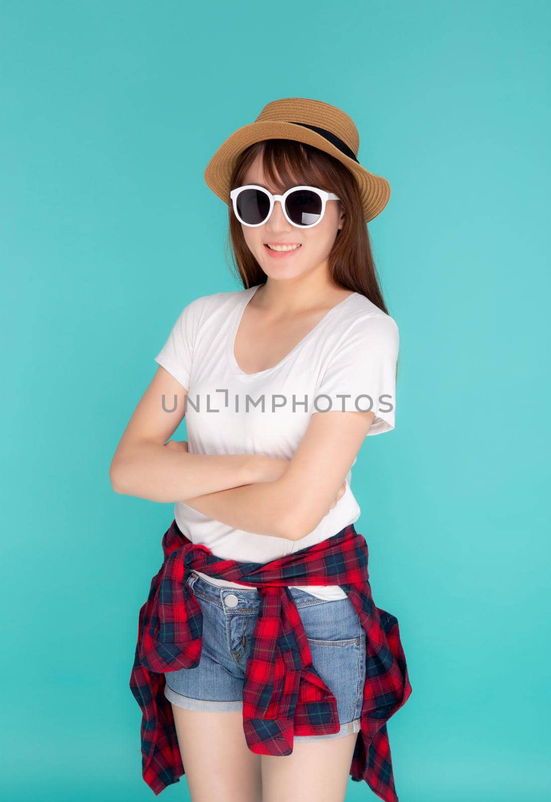 Beautiful portrait young asian woman wear hat and sunglasses smiling expression confident enjoy summer in vacation isolated on blue background, girl cheerful wear fashion travel concept.