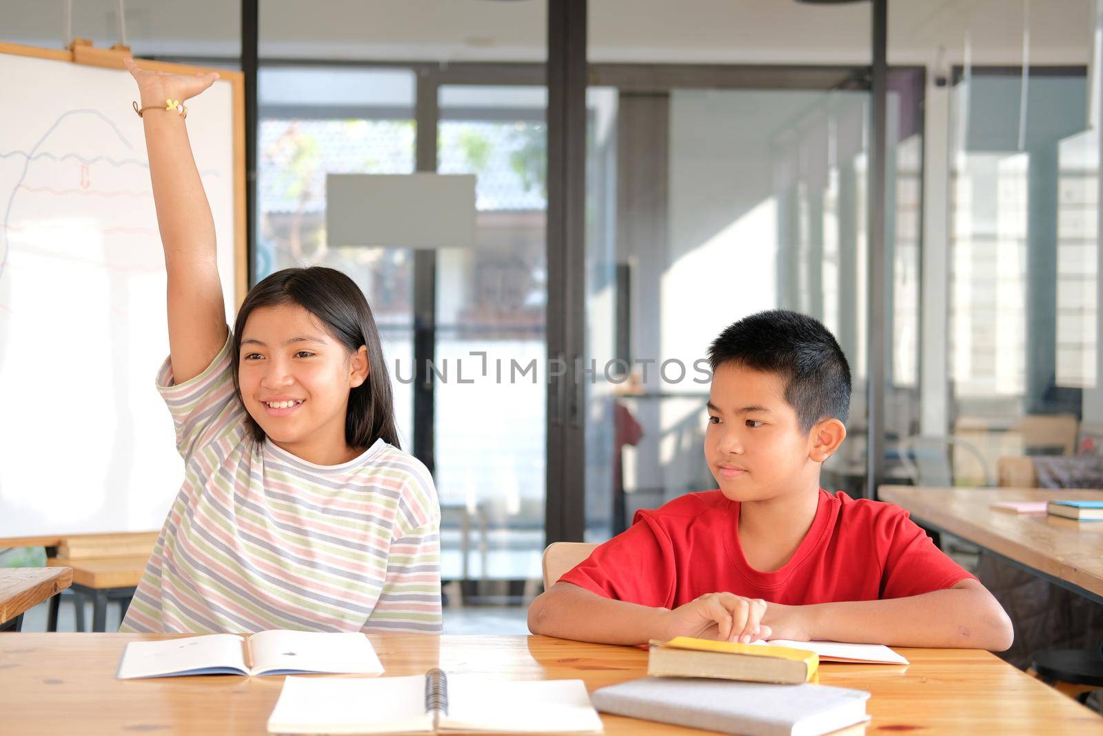 asian girl boy student studying raising hand in classroom. learning education at school