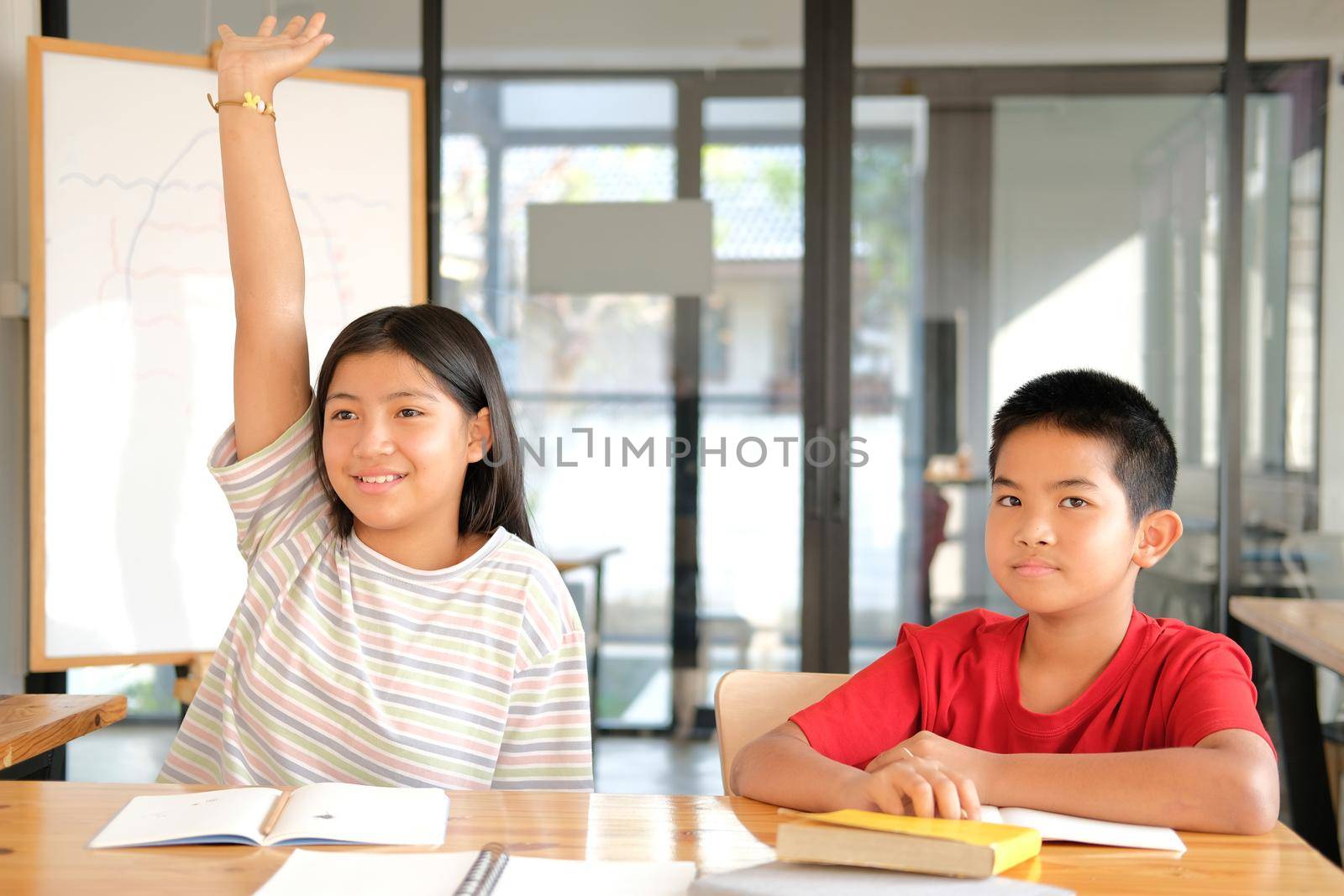 asian girl boy student studying raising hand in classroom. learning education at school