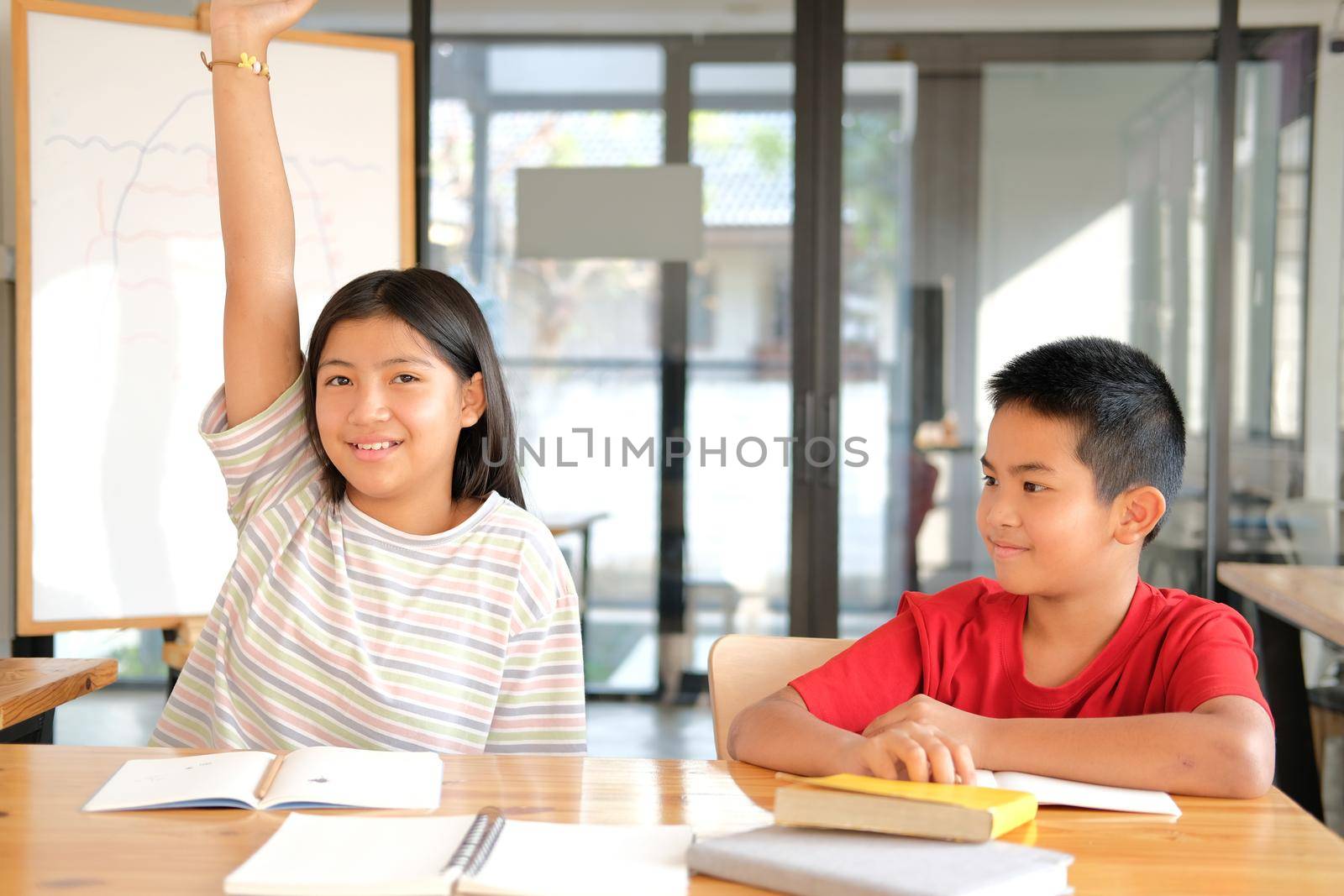 asian girl boy student studying raising hand in classroom. learning education at school