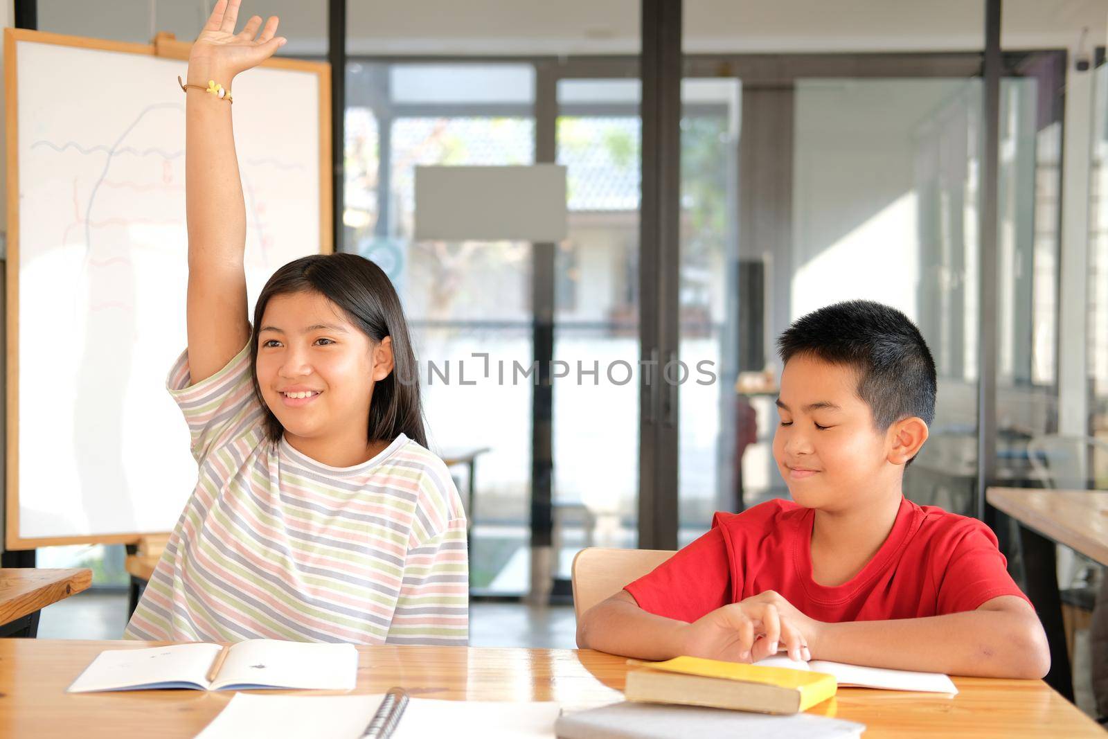 asian girl boy student studying raising hand in classroom. learning education at school