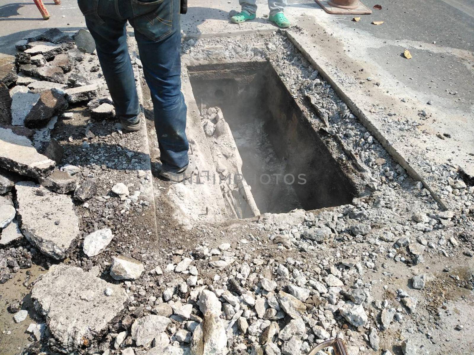 Chiang Mai, Thailand - January 27, 2021: workers digging sewer for fixing repairing underground utility service cable on Sripoom road in Chiang Mai, Thailand on January 27, 2021.