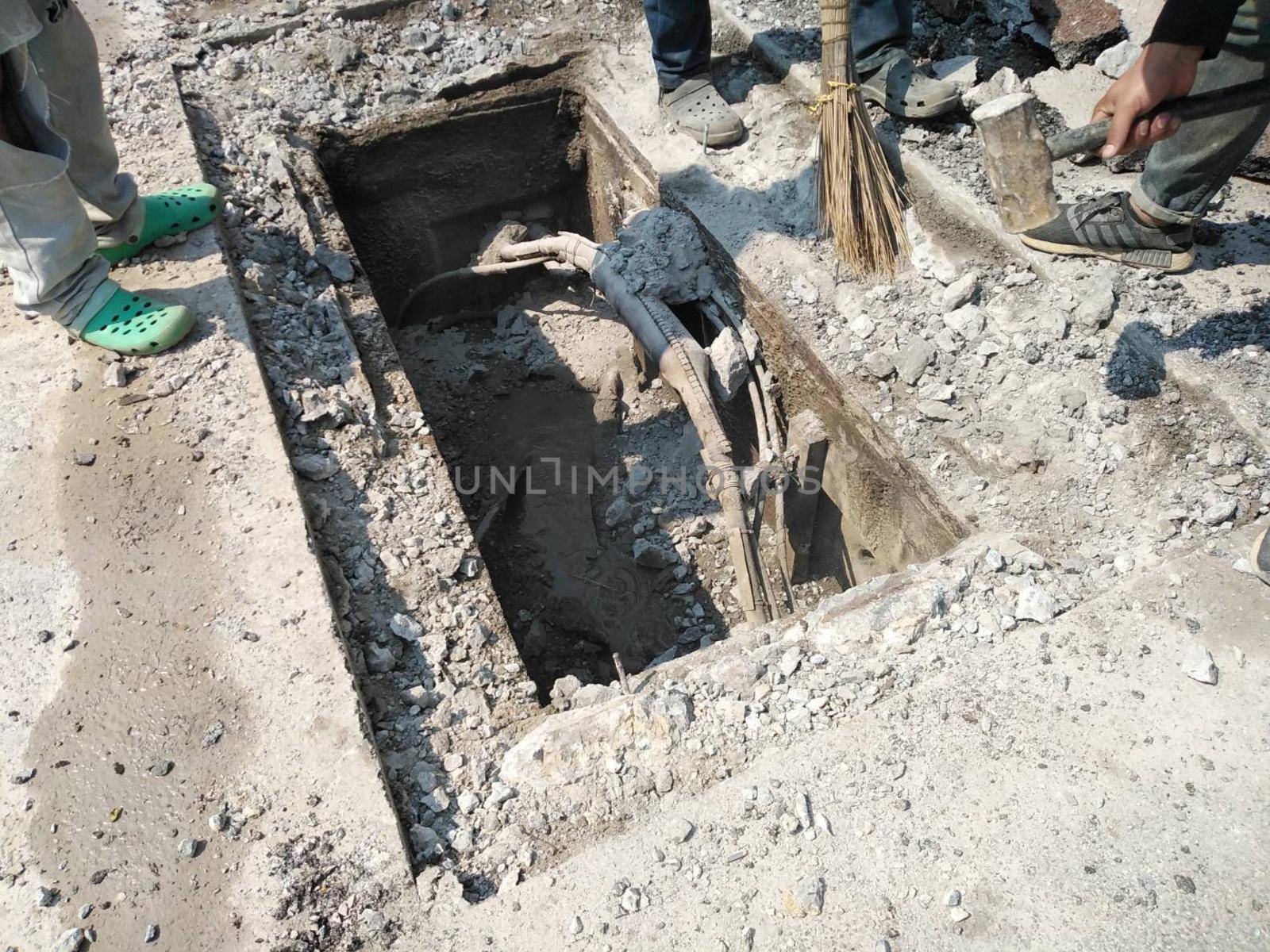 Chiang Mai, Thailand - January 27, 2021: workers digging sewer for fixing repairing underground utility service cable on Sripoom road in Chiang Mai, Thailand on January 27, 2021.