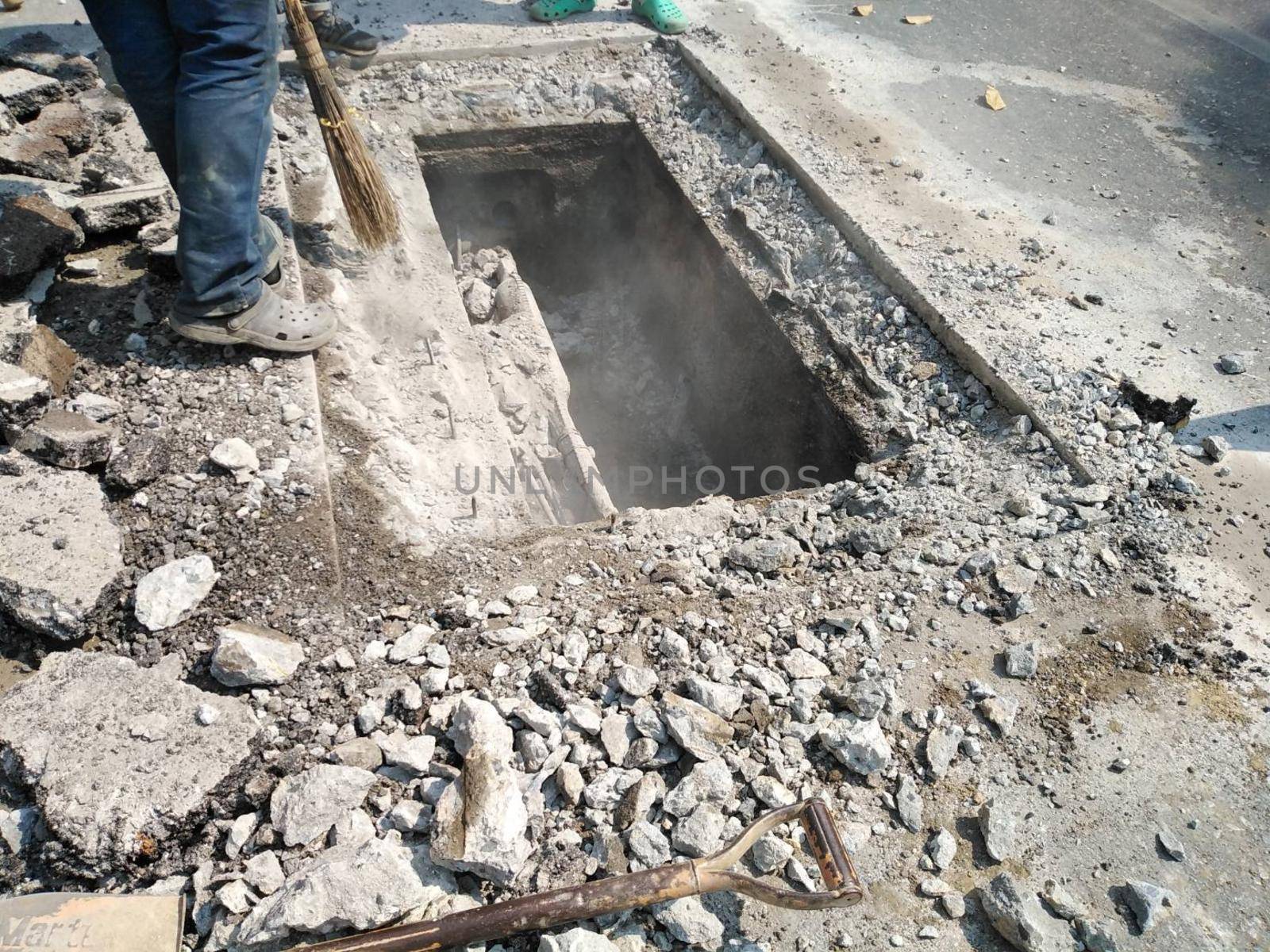 Chiang Mai, Thailand - January 27, 2021: workers digging sewer for fixing repairing underground utility service cable on Sripoom road in Chiang Mai, Thailand on January 27, 2021.