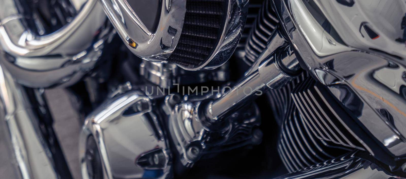 Selective focus on a motorcycle engine. Shiny chrome motorbike engine detail. Vintage motorbike. Closeup motorcycle air filter. Motorcycle industry.