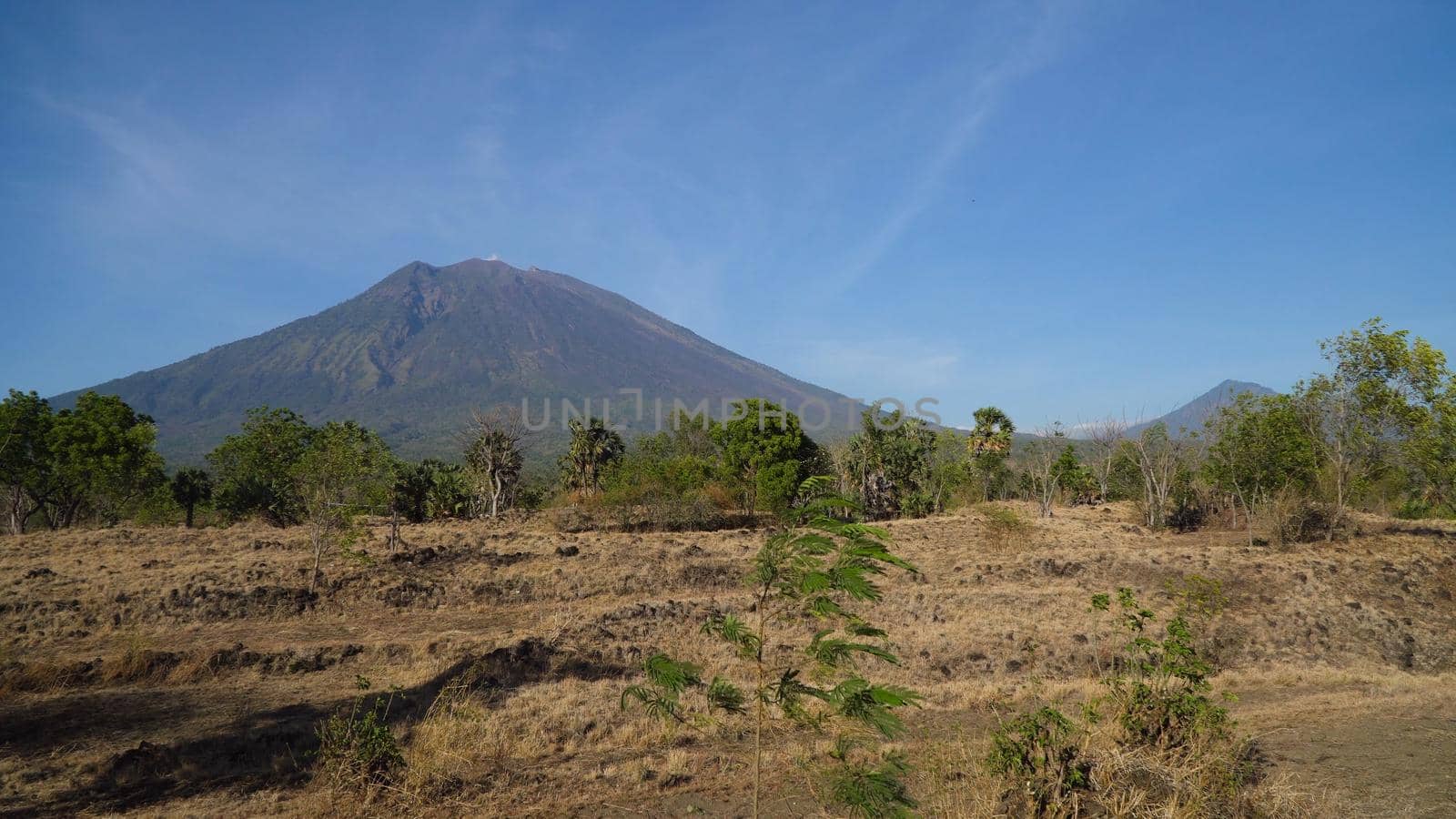 Agung, mountain, mountains covered with green forest, trees with sky and clouds. Slopes of the mountains are covered with forest in Asia. Bali,Indonesia. Travel concept.