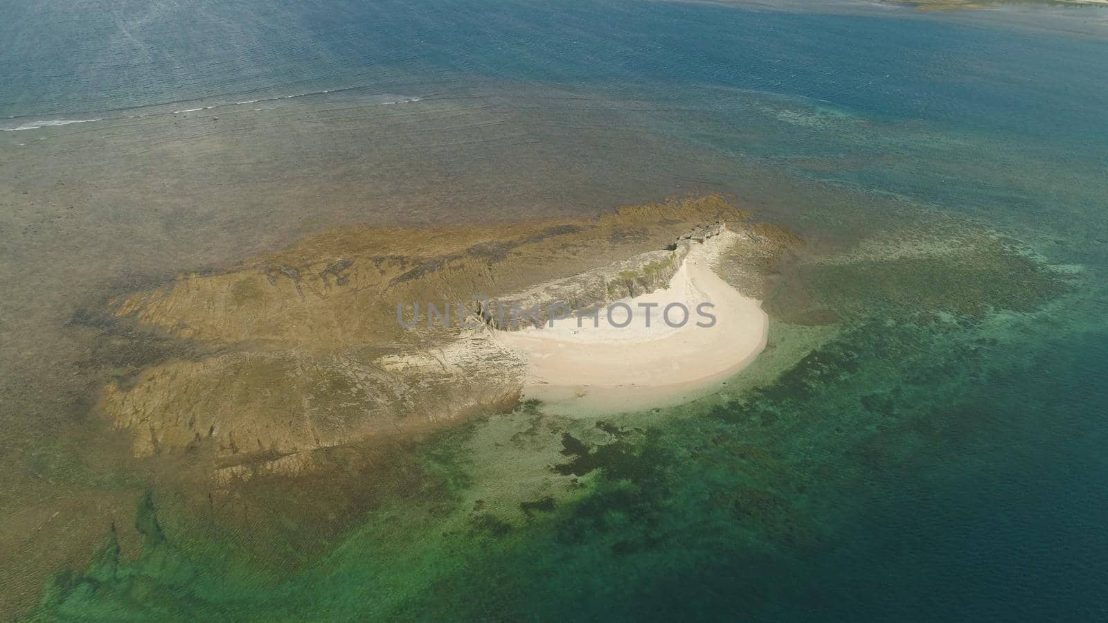 Tropical island with white sandy beach. Aerial view of sandy Crocodile island with colorful reef. Santa Ana Seascape, ocean and beautiful beach. Philippines. Travel concept.