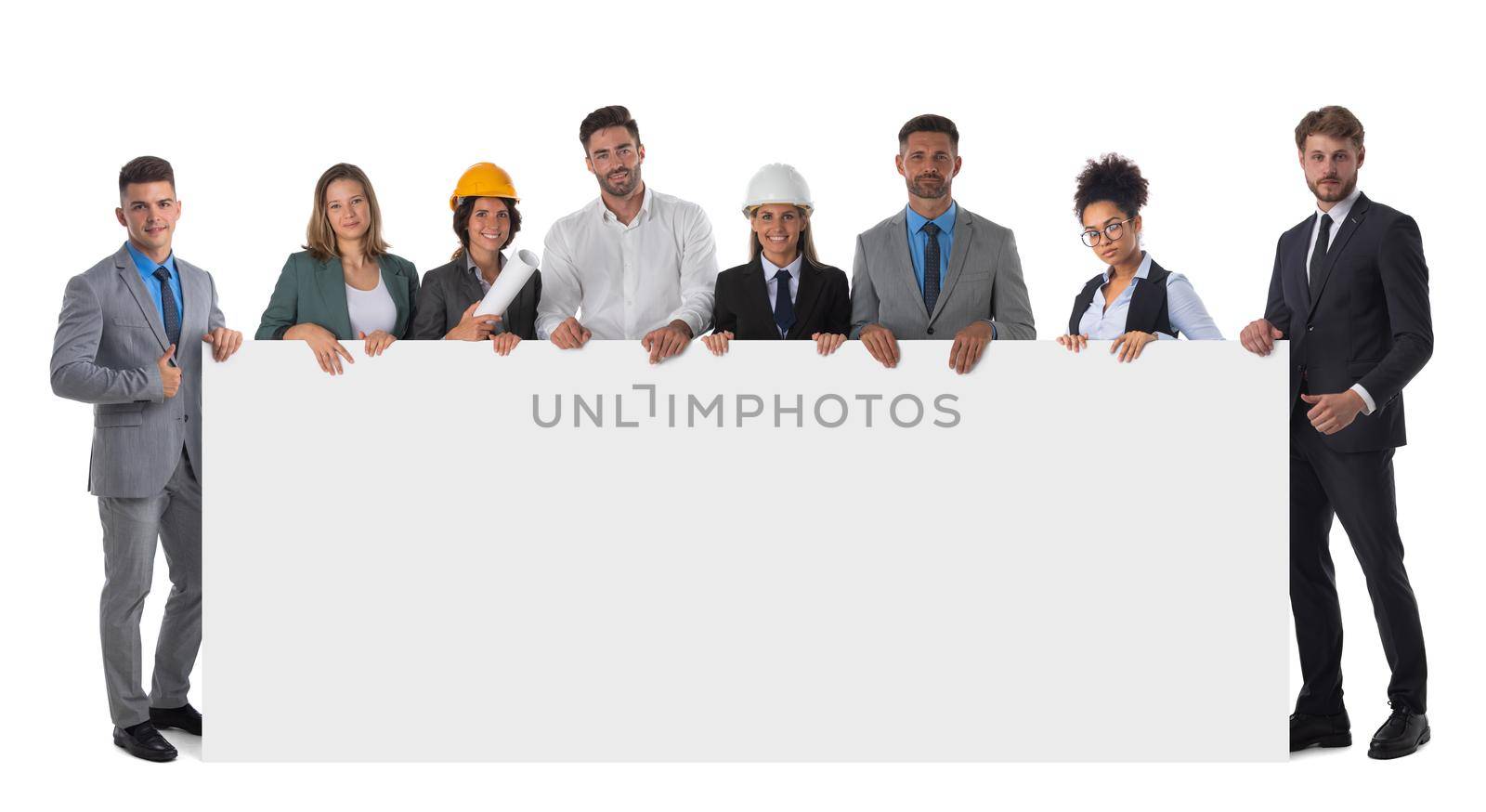 Group of happy multi ethnic architects and business people holding blank banner ad isolated on white background