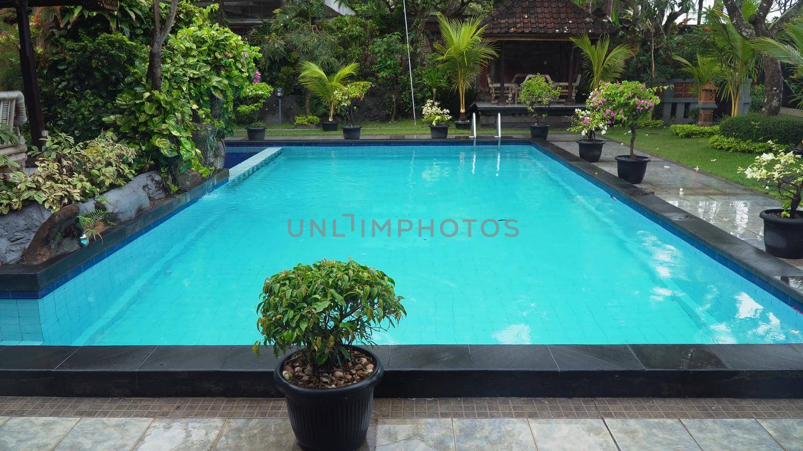 Luxurious open air swimming pool at resort. Swimming pool with turquoise water in a luxury hotel. Travel concept.