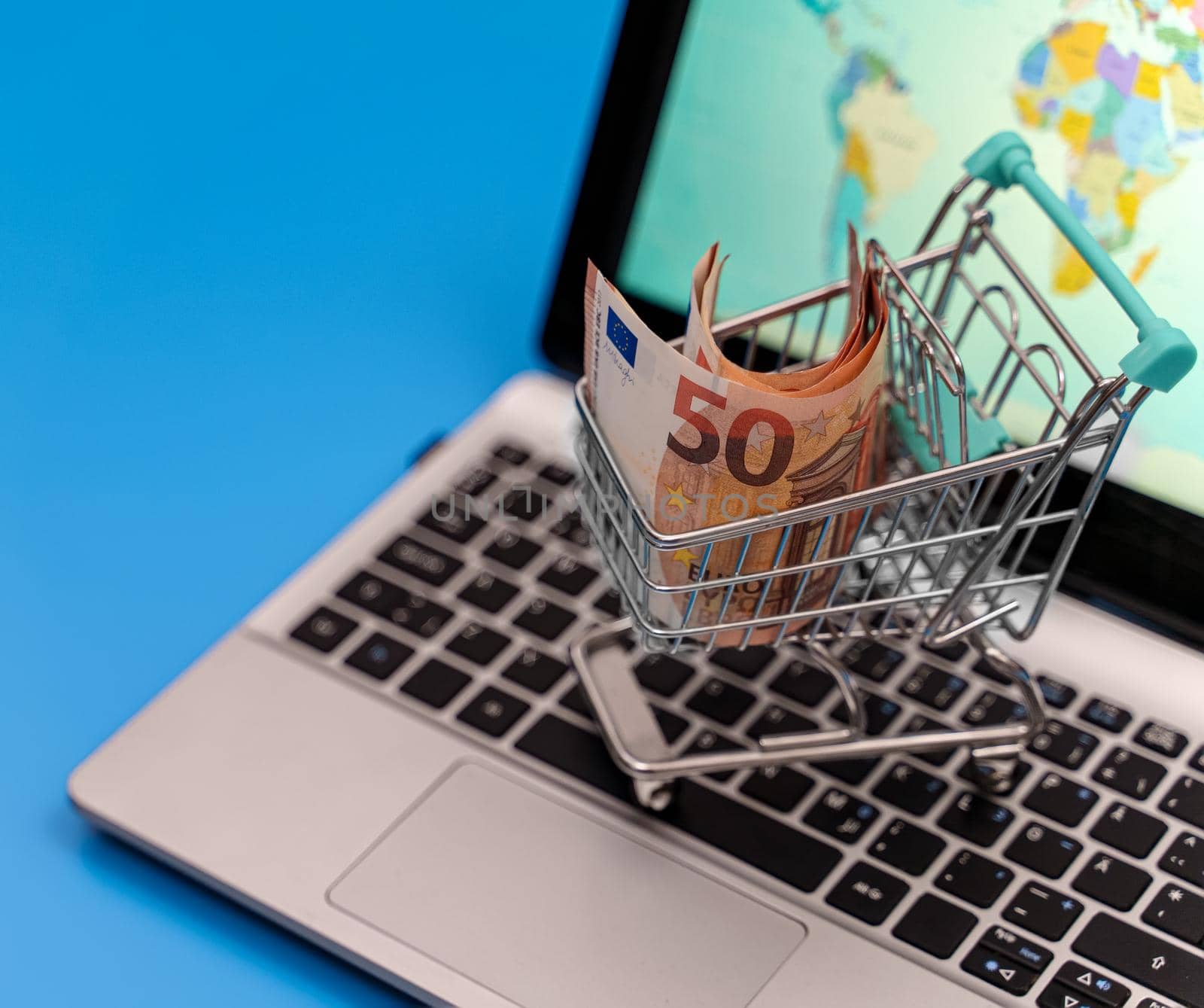 Shopping cart with euro banknotes. Online shopping concept.