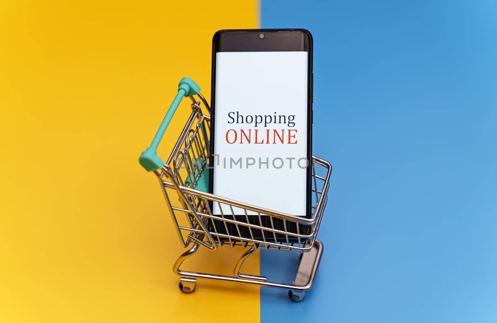 Shopping cart with smartphone. Online shopping concept. by dmitrimaruta