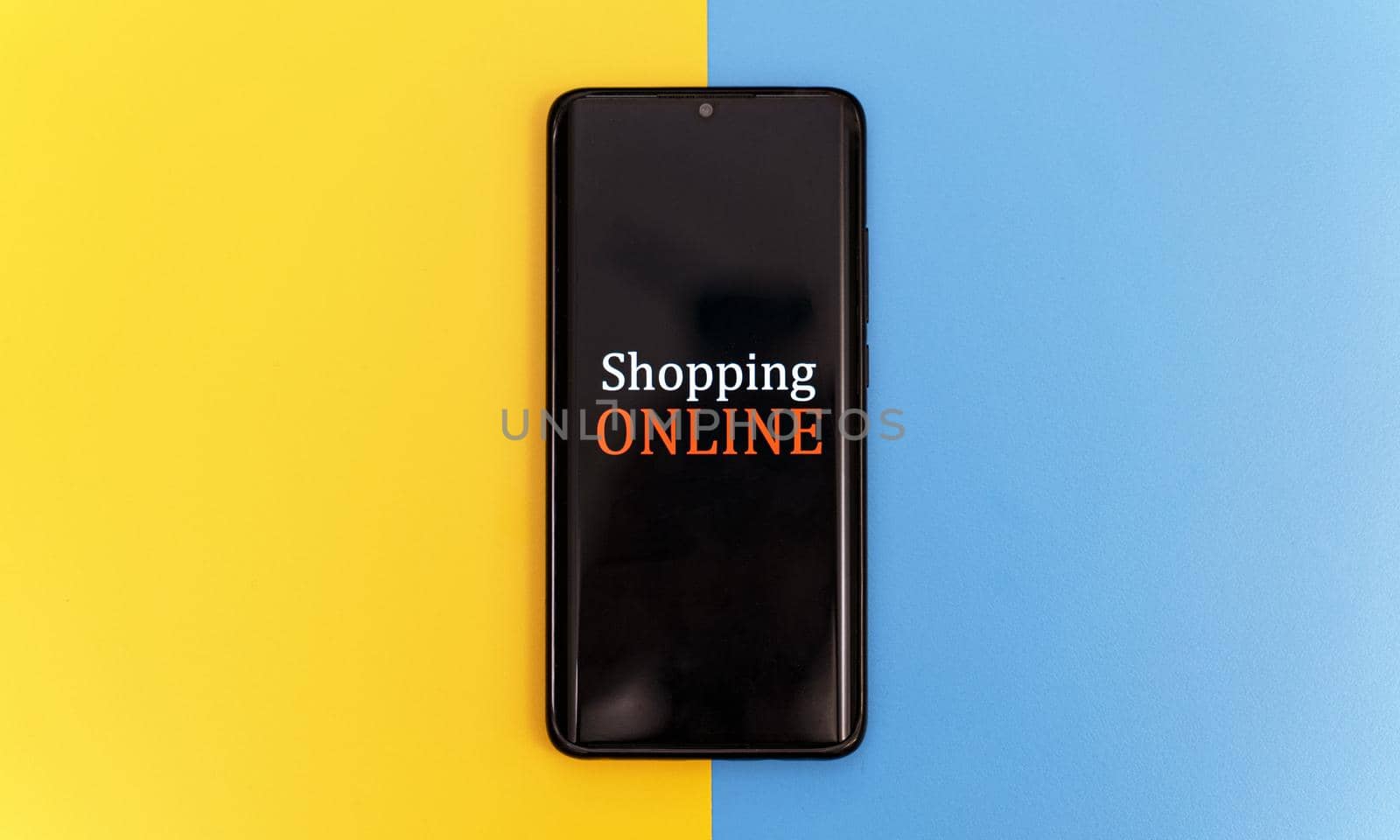 Smartphone on yellow and blue background. Online shopping concept. by dmitrimaruta