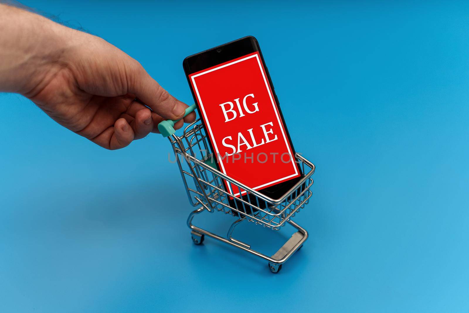 Shopping cart with smartphone. Big sale concept. by dmitrimaruta